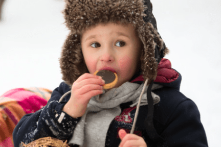 a little boy that is eating some food