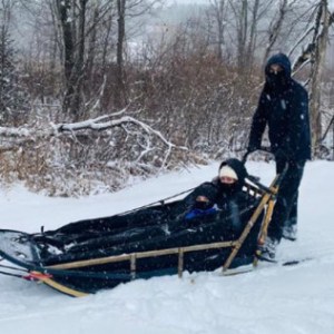 a group of people riding skis across snow covered ground
