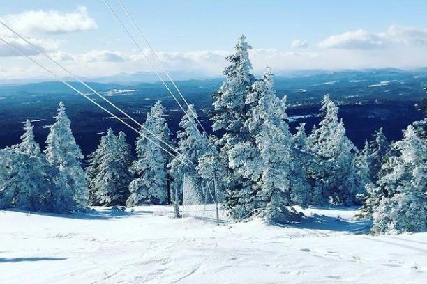 a person riding skis down a snow covered slope