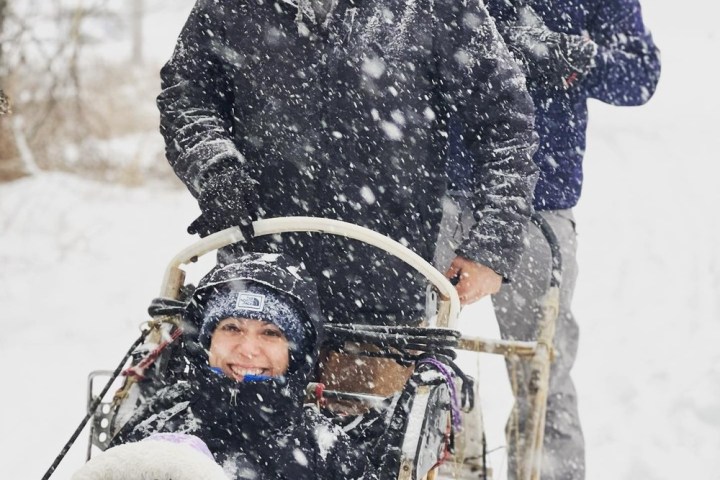 a man riding a snowboard down a snow covered slope