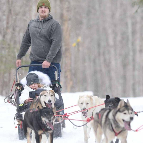 a man and a dog in the snow