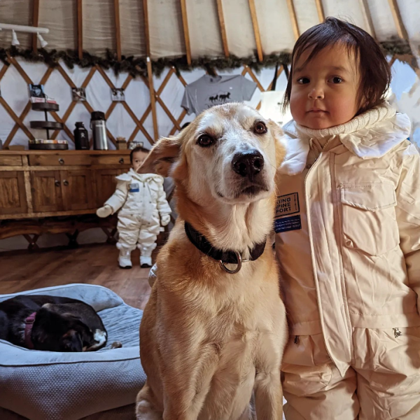 a person standing next to a dog