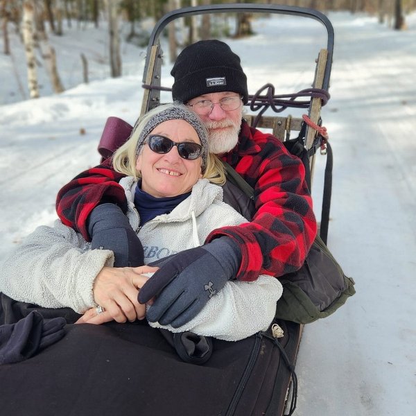 a person is sitting in the snow